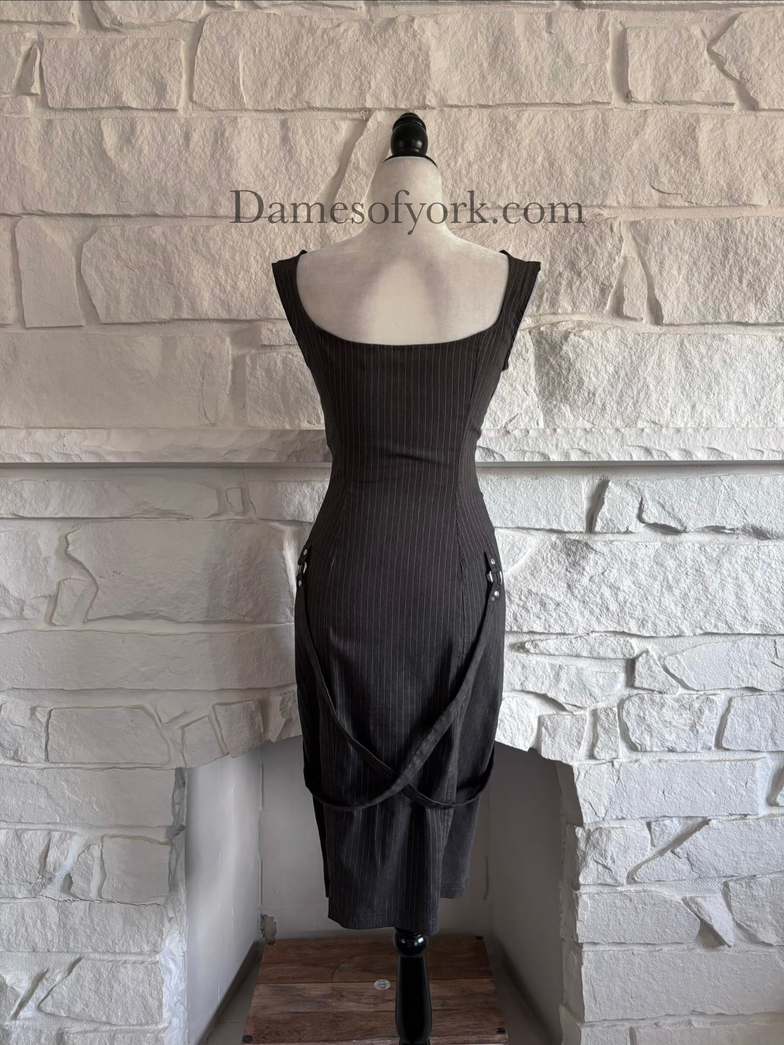 Back view of grey pinstripe gothic dress on mannequin with knee length pencil skirt