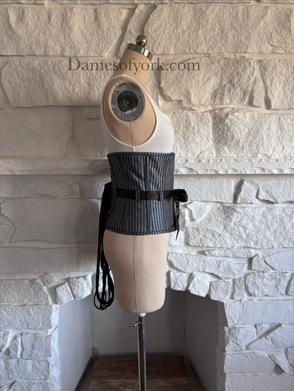 Side view of grey striped corset on mannequin with steel boning and fitted silhouette