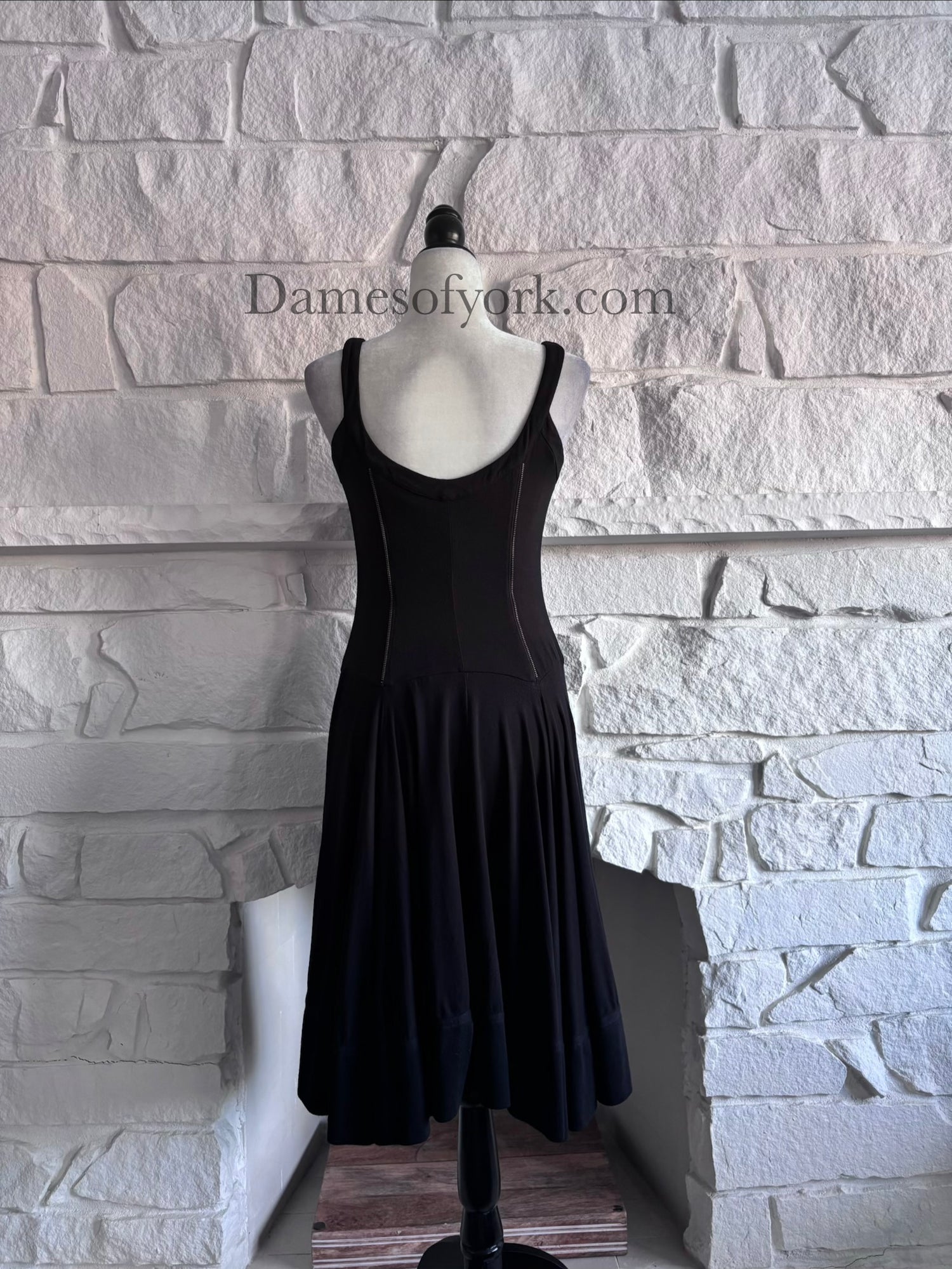 Back view of the Ironheart Zipper Dress showing the clean black dress design and flared skirt.