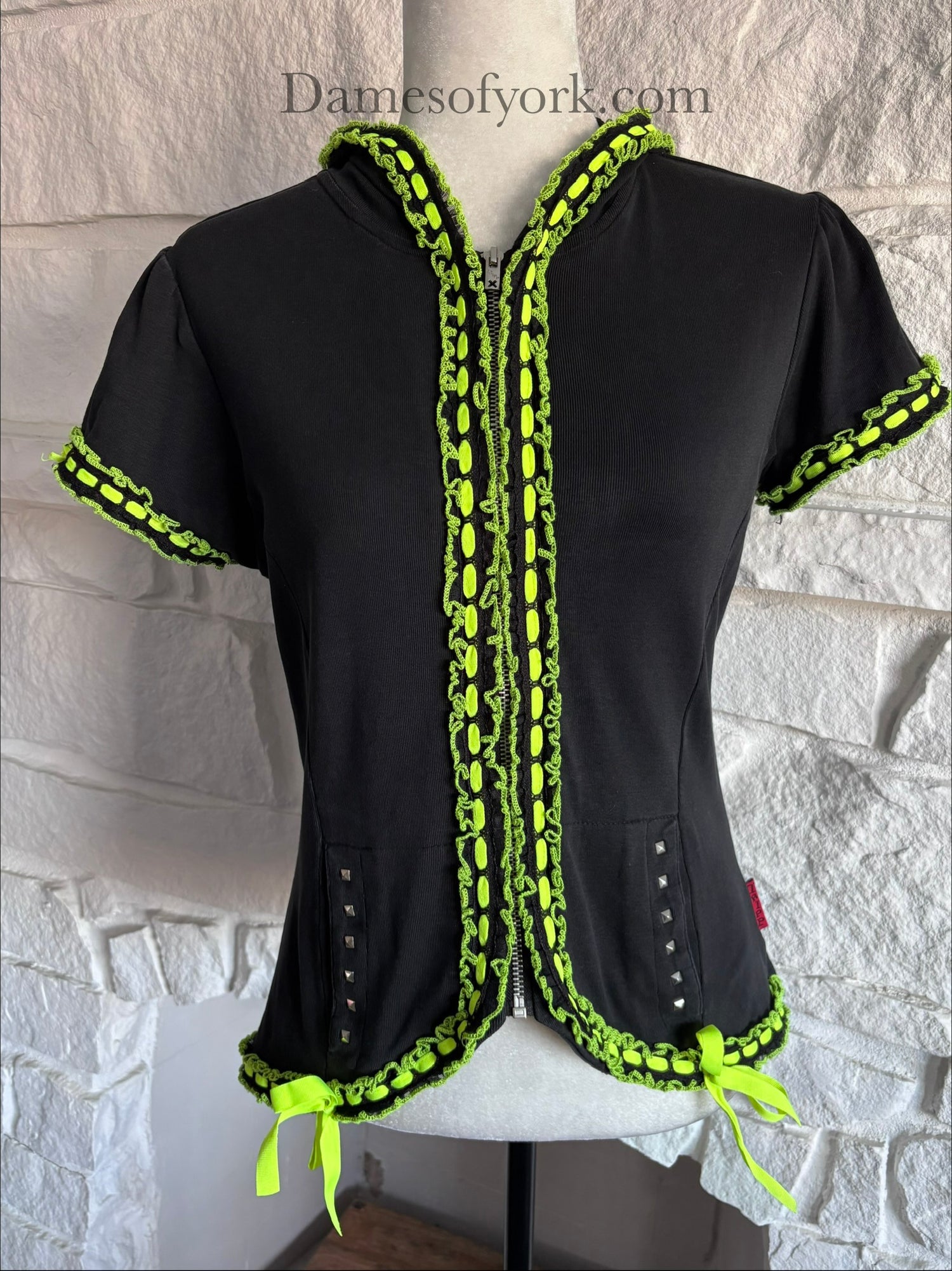 Close-up detail of the Neon Pulse Hoodie featuring the neon lace and ribbon trim and studded pocket details.