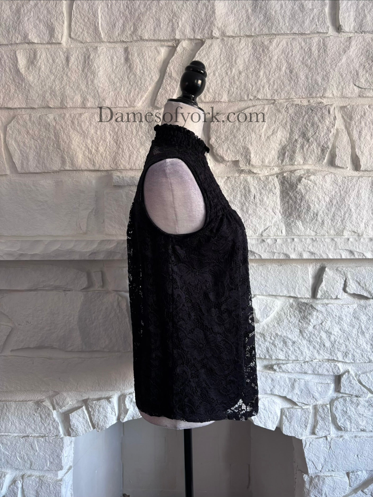 Side view of the Nocturne Lace Blouse highlighting the sleeveless cut and delicate lace fabric.