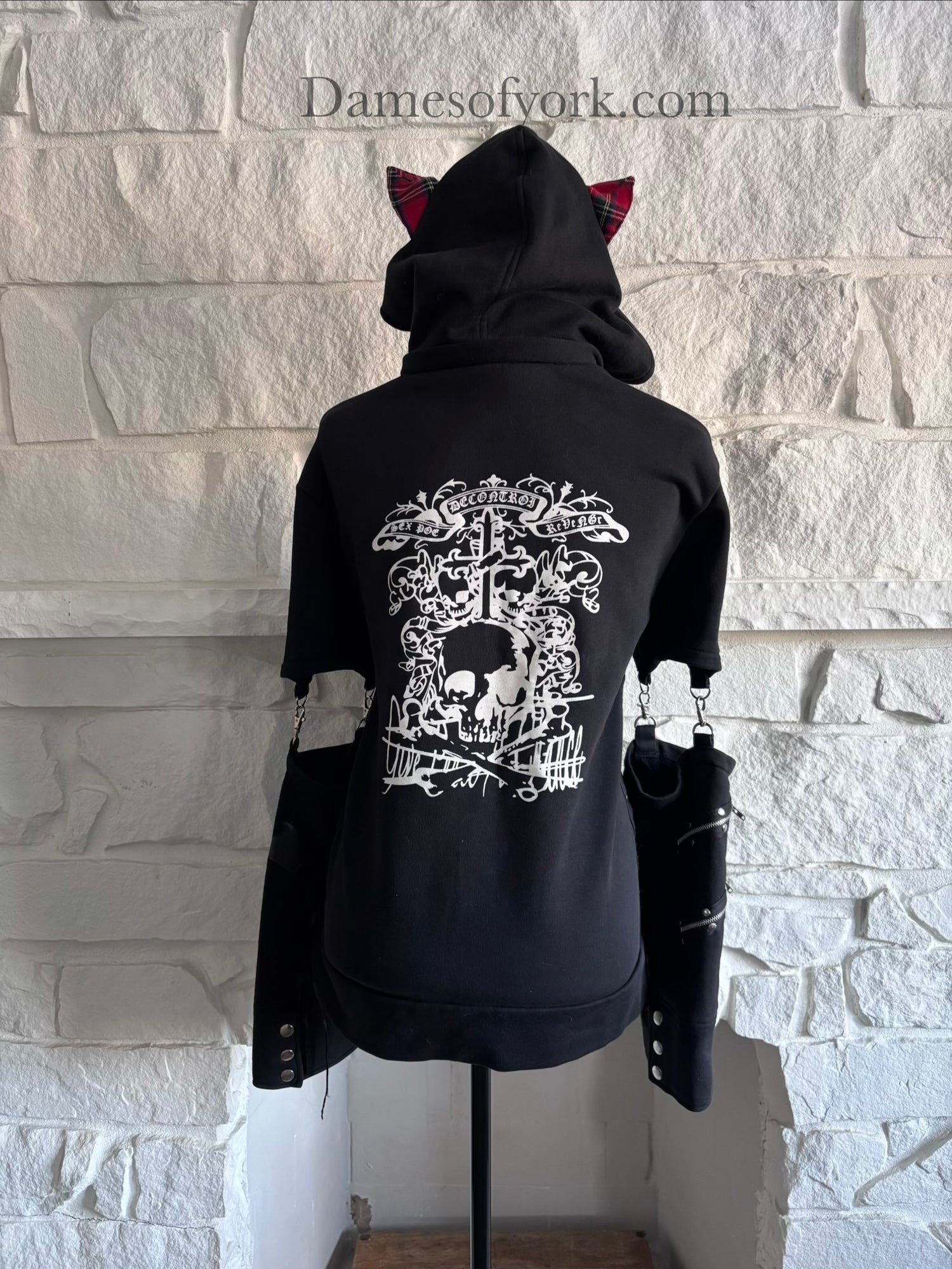 Back view of the Stray Voltage Hoodie showing the detachable hood with red plaid lining and cat ears with the hood up.