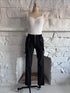Front view of the Strapline Suspender Pants, black stretch pants with suspenders and a front silver zipper.