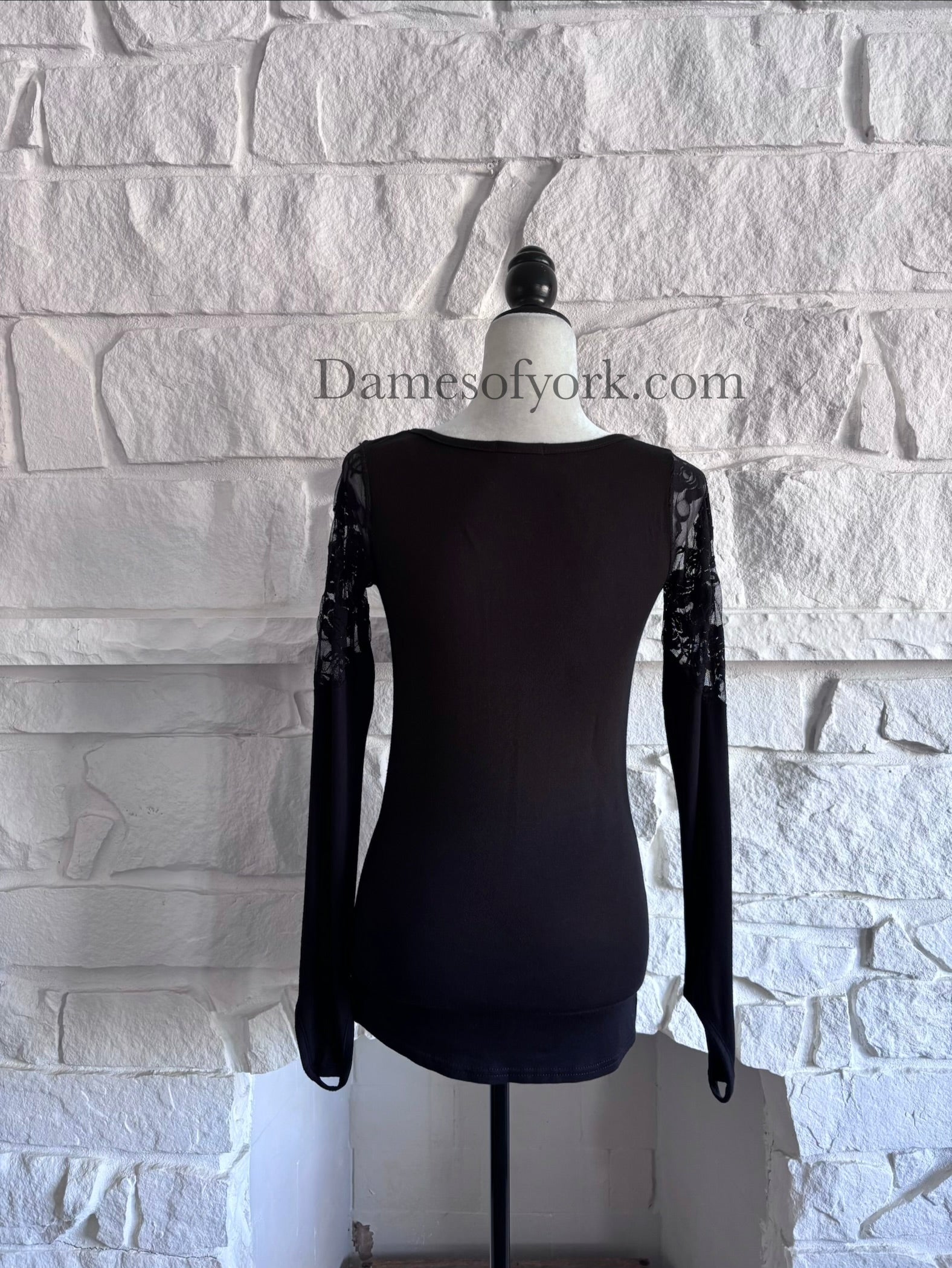 Back view of the Graveyard Radio Top showing the soft black knit fabric and long sleeve design.