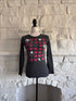 Front view of grey long sleeve graphic t-shirt on mannequin with heart, skull and lightning bolt print.