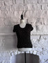 Front view of black crinkle texture top on mannequin with tentacle-like raised pattern