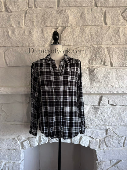 Front view of black and white plaid long sleeve shirt on mannequin with button-up closure