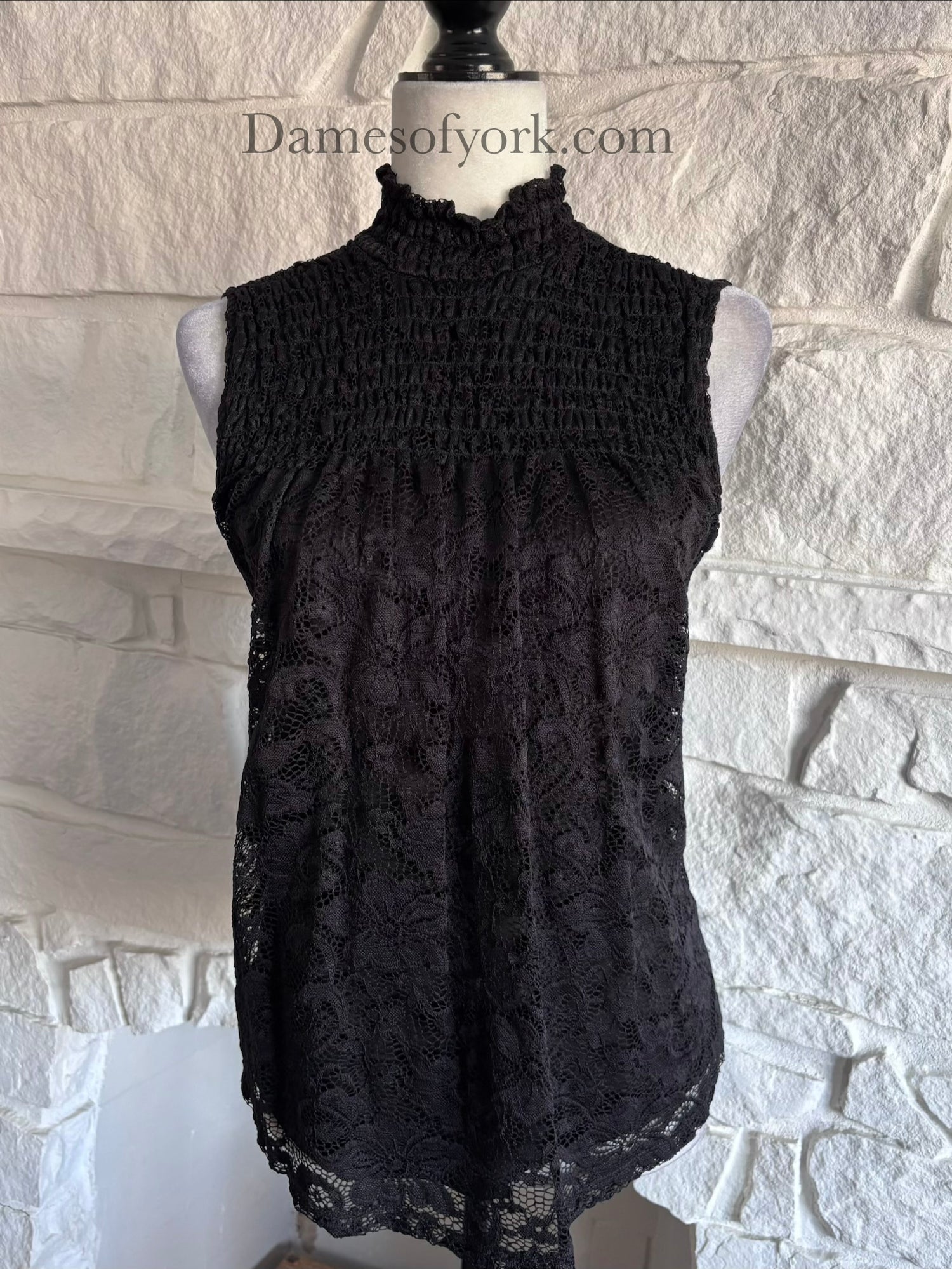 Close-up detail of the Nocturne Lace Blouse featuring the lace overlay and frilled high neckline.