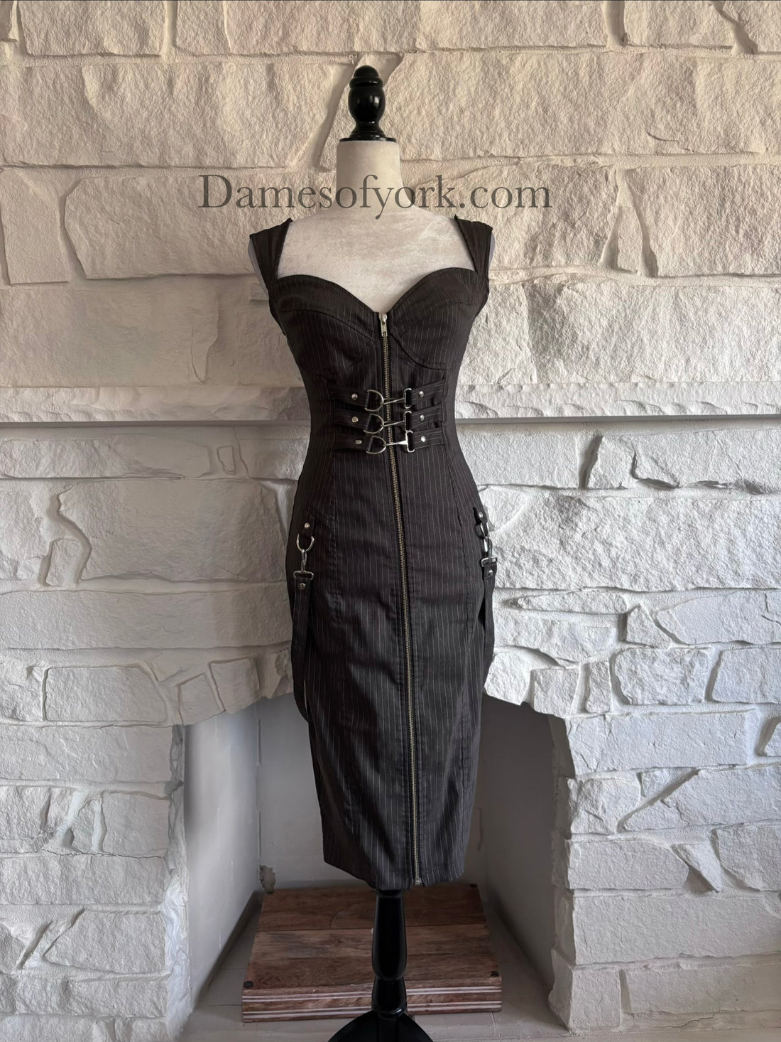 Front view of grey pinstripe fitted dress on mannequin with sweetheart neckline and front zipper