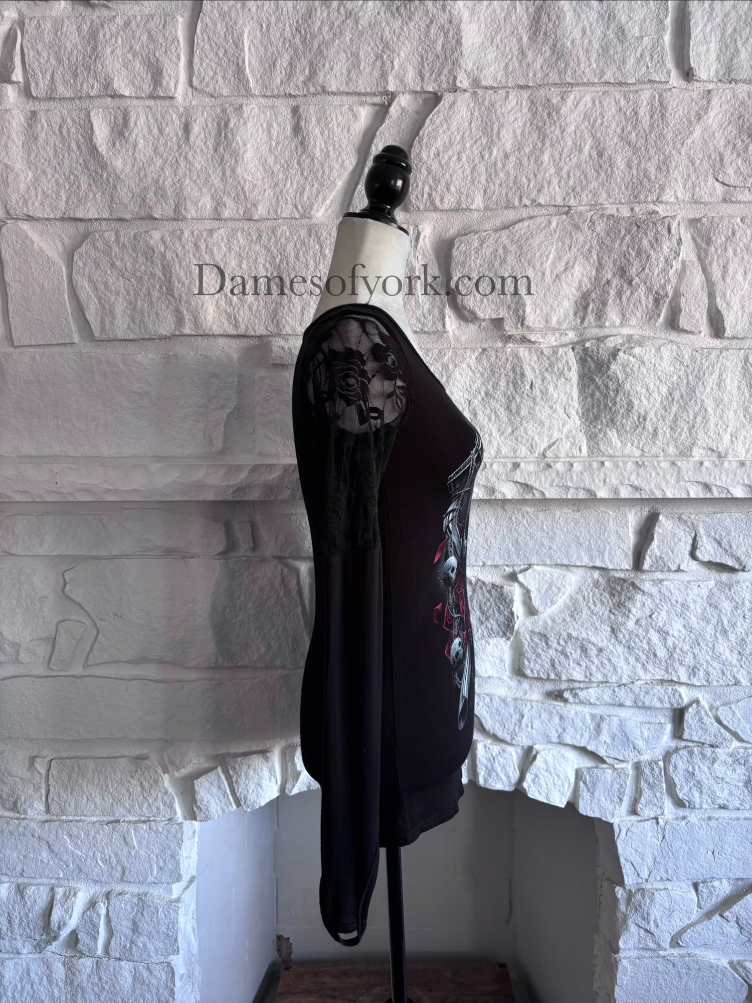 Side view of the Graveyard Radio Top highlighting the sheer lace sleeve panels and fitted silhouette.