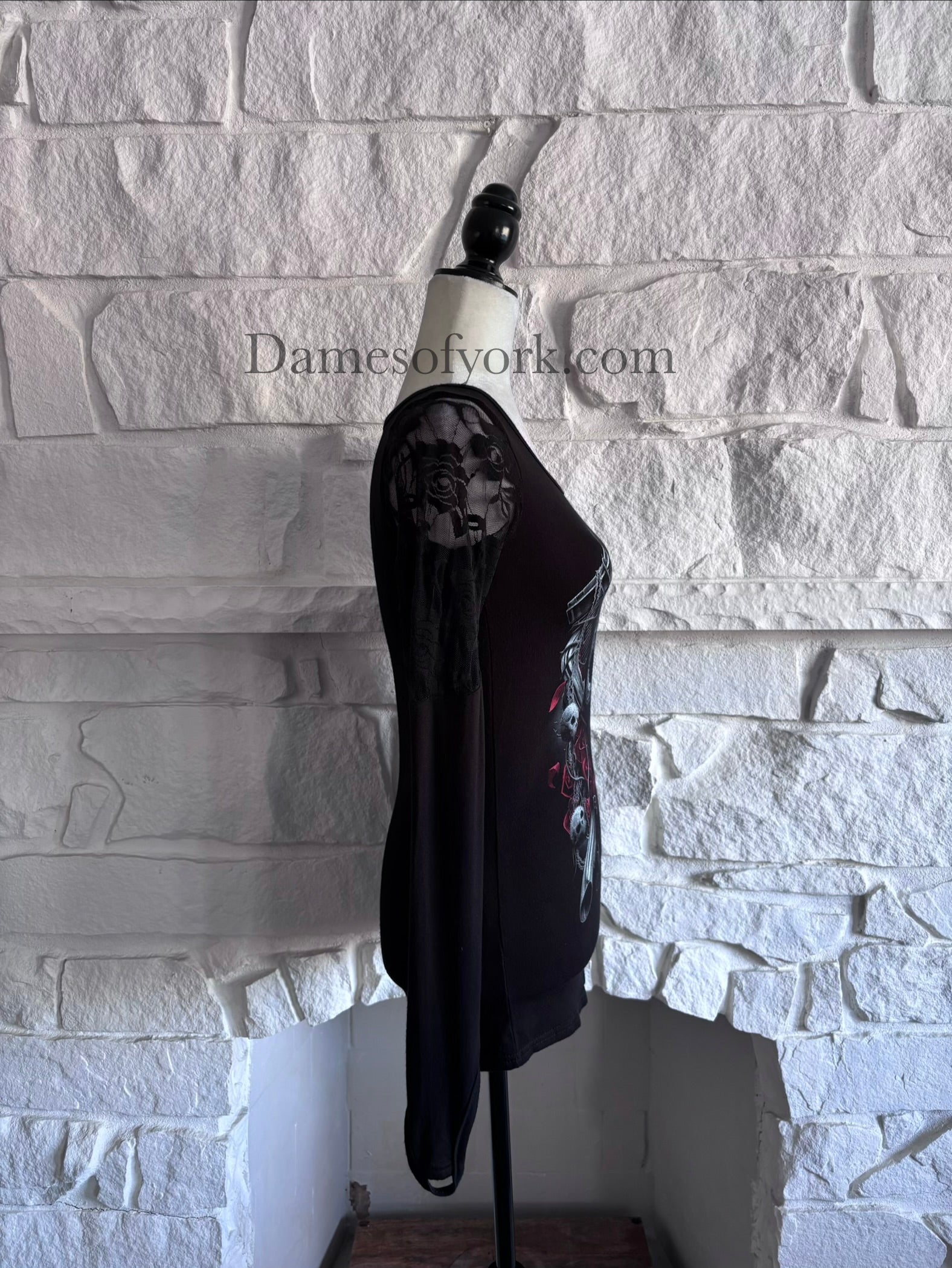 Side view of the Graveyard Radio Top highlighting the sheer lace sleeve panels and fitted silhouette.