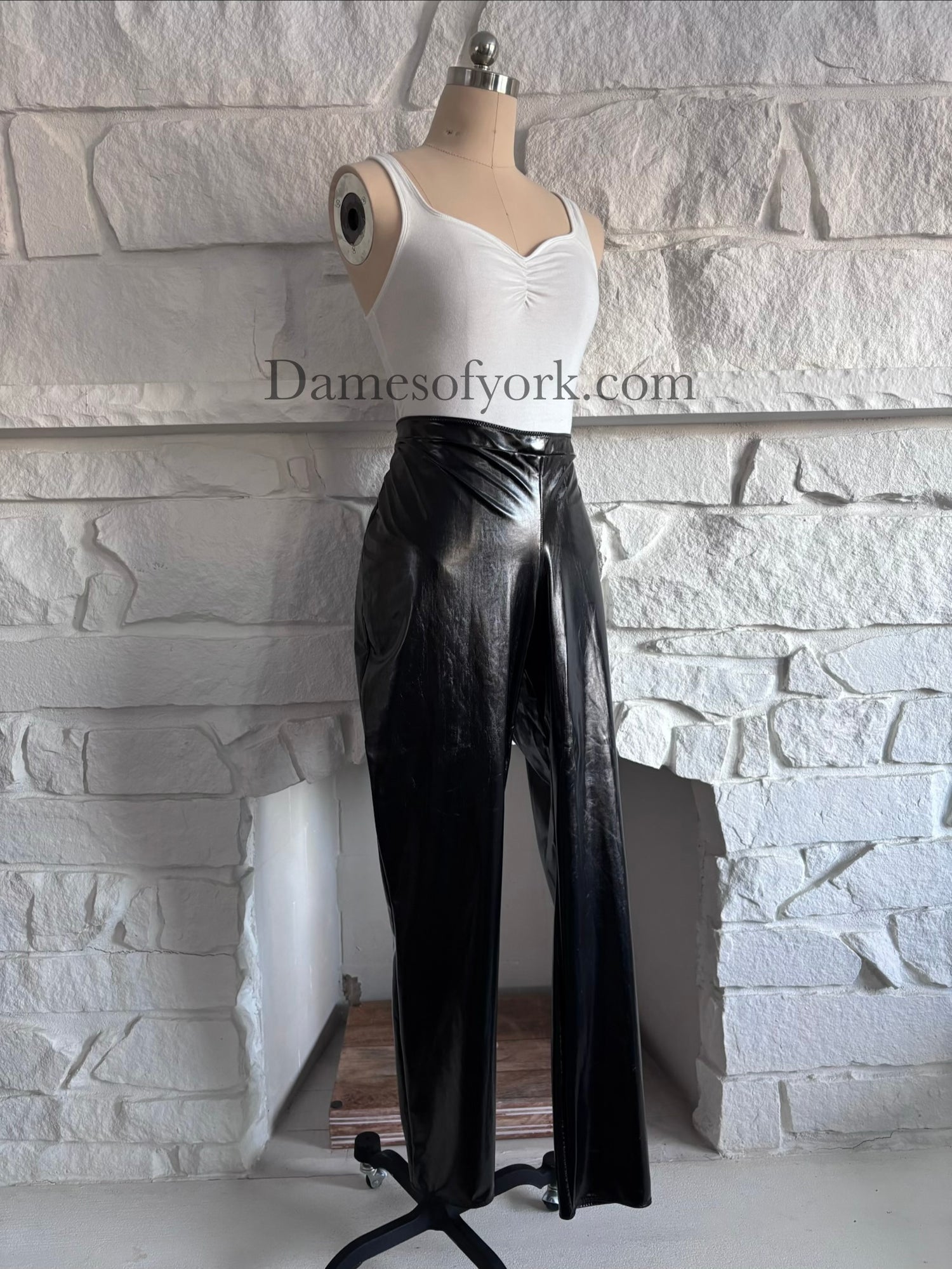 Angled view of the Glossy PVC Leggings showing the glossy PVC material and form-fitting design.