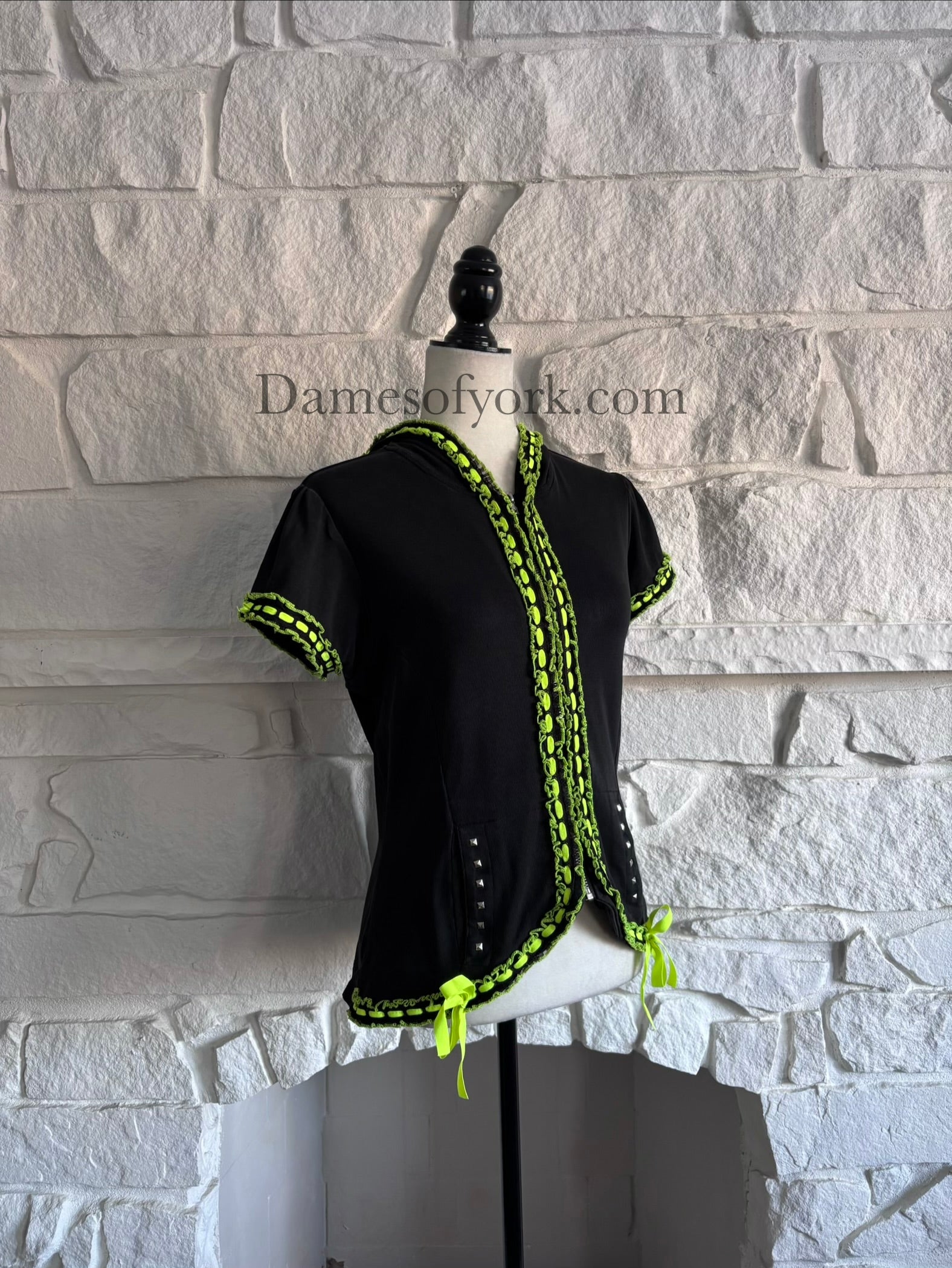 Angled view of the Neon Pulse Hoodie showing the neon lace and ribbon detailing and studded pocket openings.