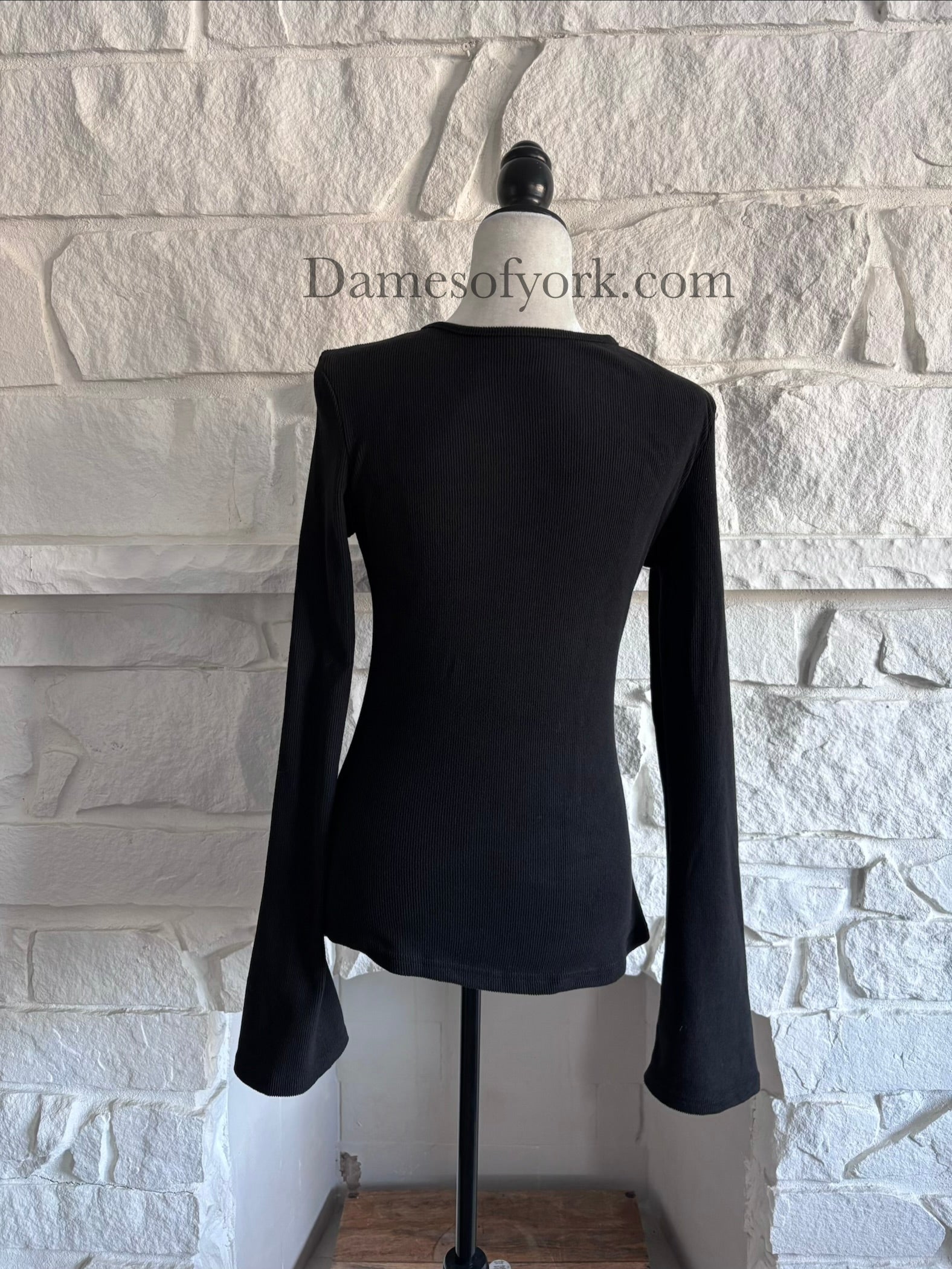 Back view of the Webbed Phantom Sweatshirt showing the simple black knit design and long flared sleeves.