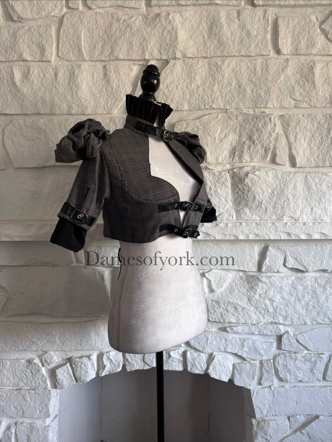 Diagonal view of fitted gothic bolero jacket on mannequin showing sweetheart neckline and structured shoulders
