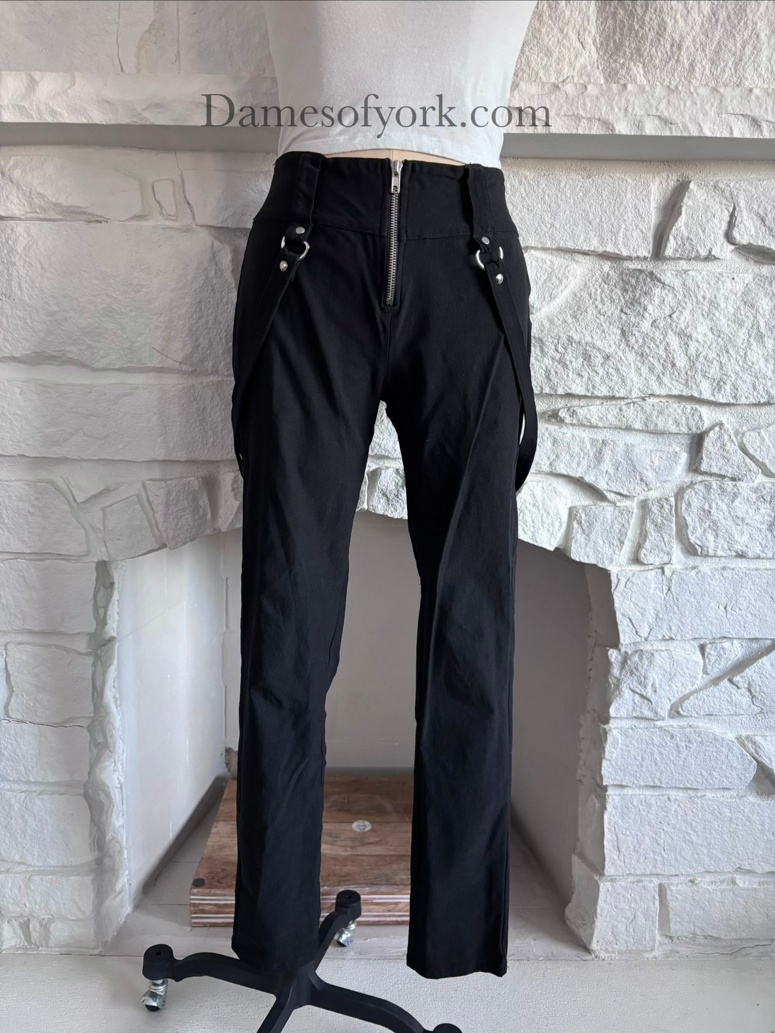 Close-up detail of the front of the Strapline Suspender Pants featuring the silver zipper and suspender straps.