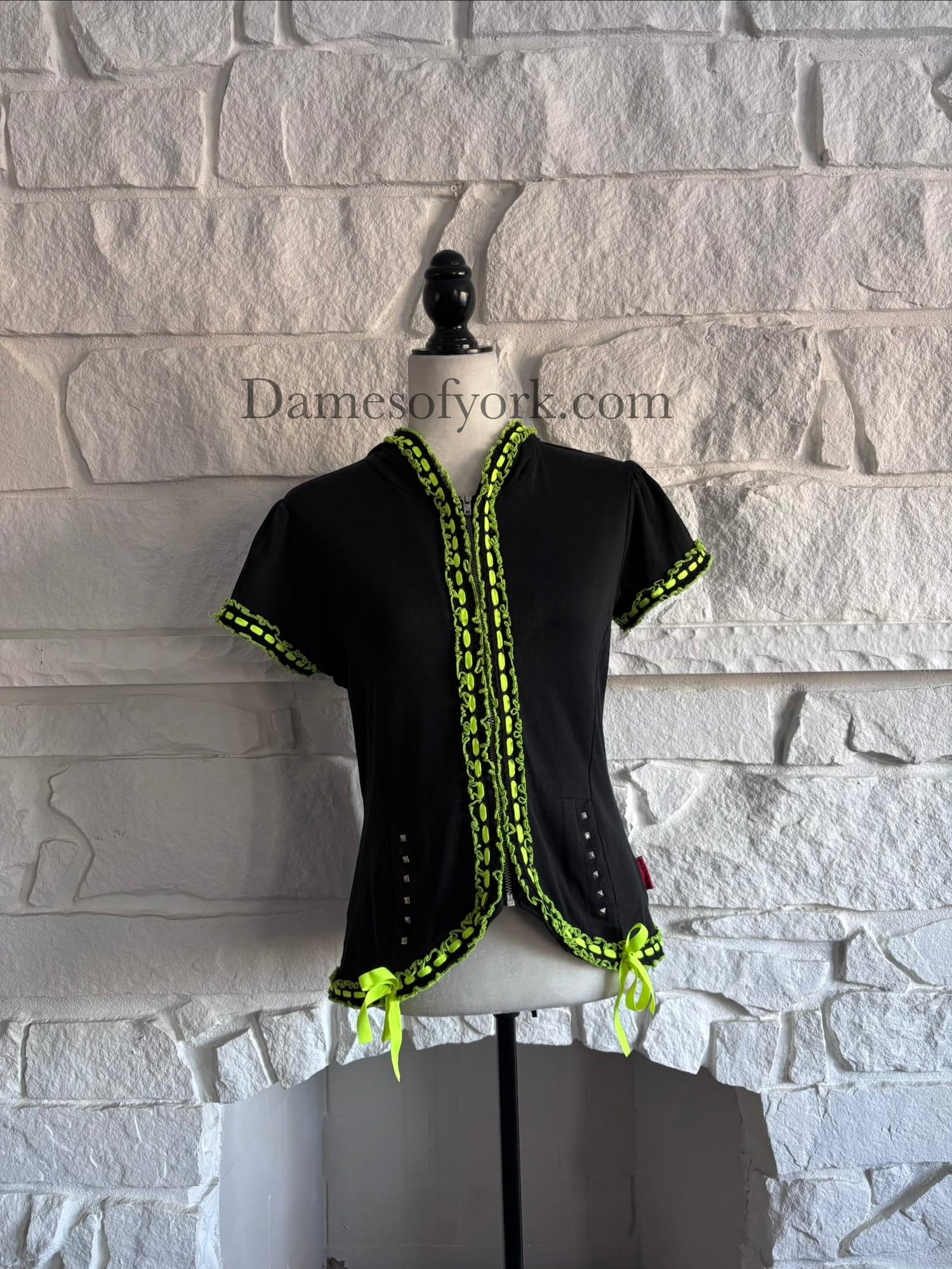 Front view of the Neon Pulse Hoodie, a black short sleeve hoodie with neon yellow-green lace and ribbon trim and a front zipper.