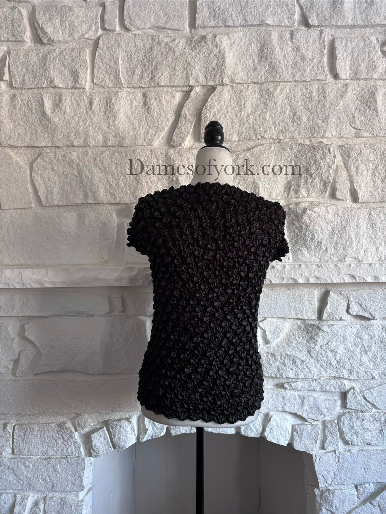 Back view of black alien-inspired crinkle shrink top on mannequin