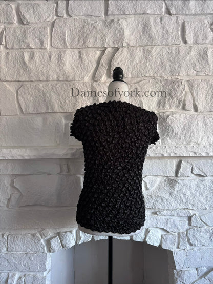 Back view of black alien-inspired crinkle shrink top on mannequin