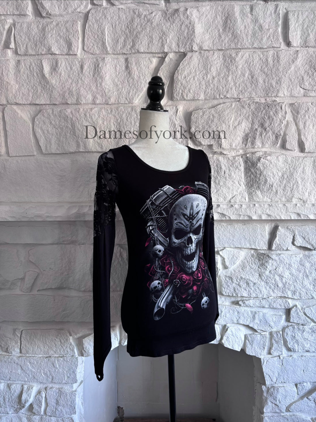 Angled view of the Graveyard Radio Top showing the skull and microphone design and lace panel sleeves.