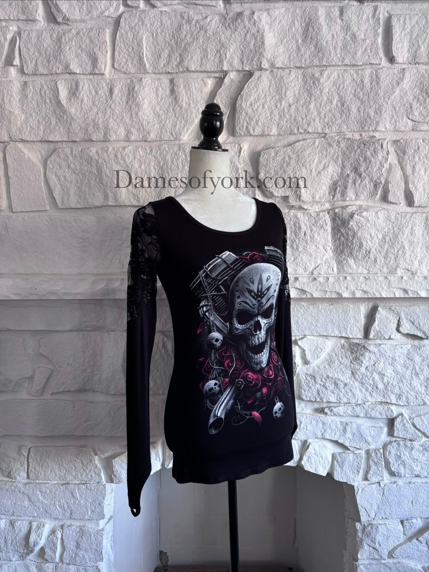 Angled view of the Graveyard Radio Top showing the skull and microphone design and lace panel sleeves.