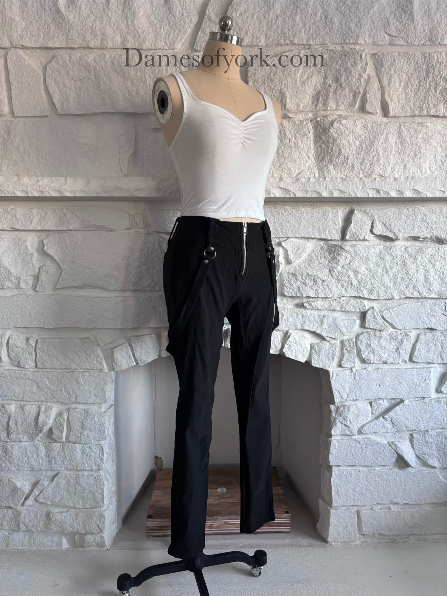 Angled view of the Strapline Suspender Pants showing the fitted silhouette and suspender straps.