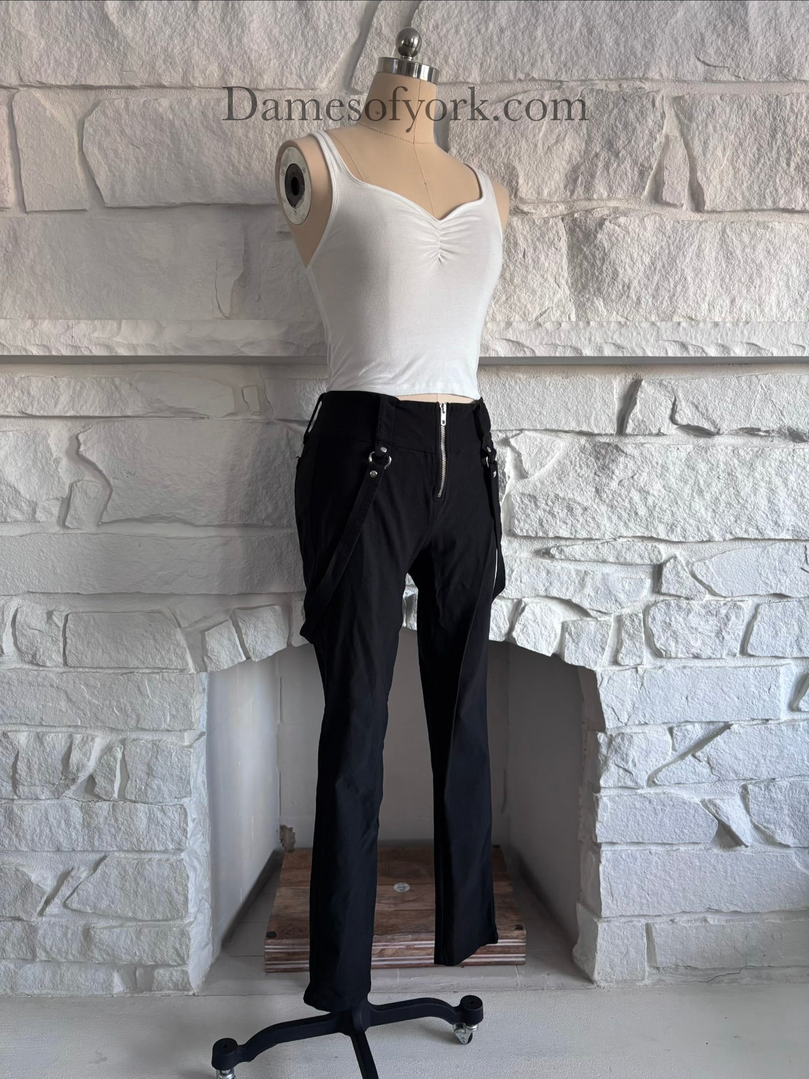 Angled view of the Strapline Suspender Pants showing the fitted silhouette and suspender straps.