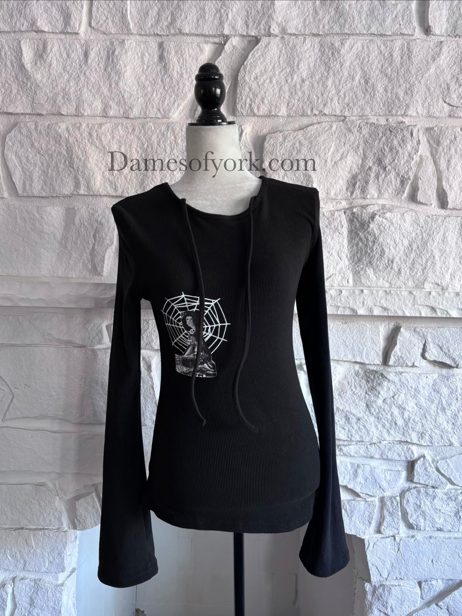 Front view of the Webbed Phantom Sweatshirt, a black knit sweatshirt with flared sleeves and a spiderweb graphic with an abstract figure on the front.