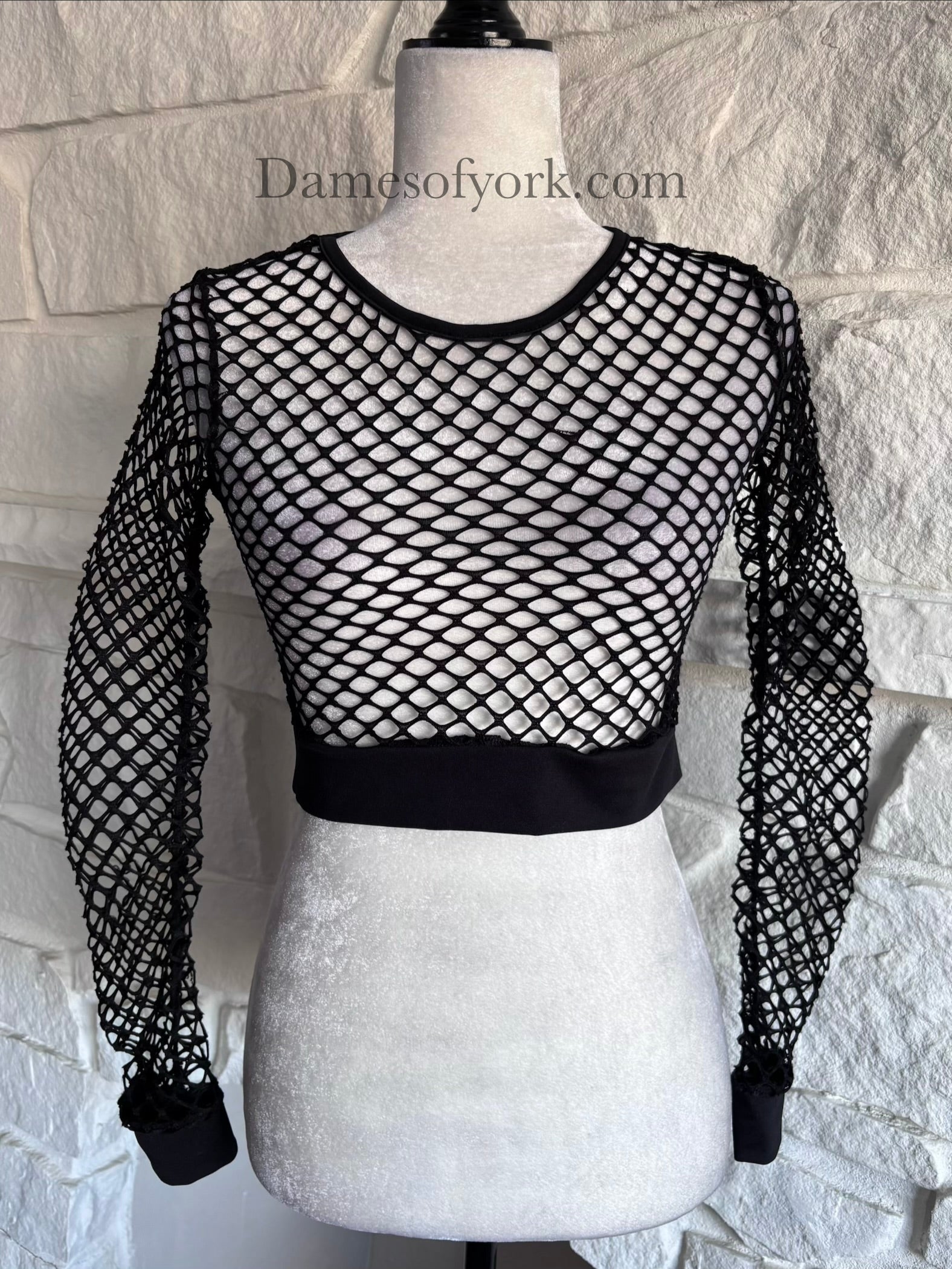 Close-up detail of the Shadow Mesh Crop Top featuring the sheer mesh fabric and elastic knit hem band.