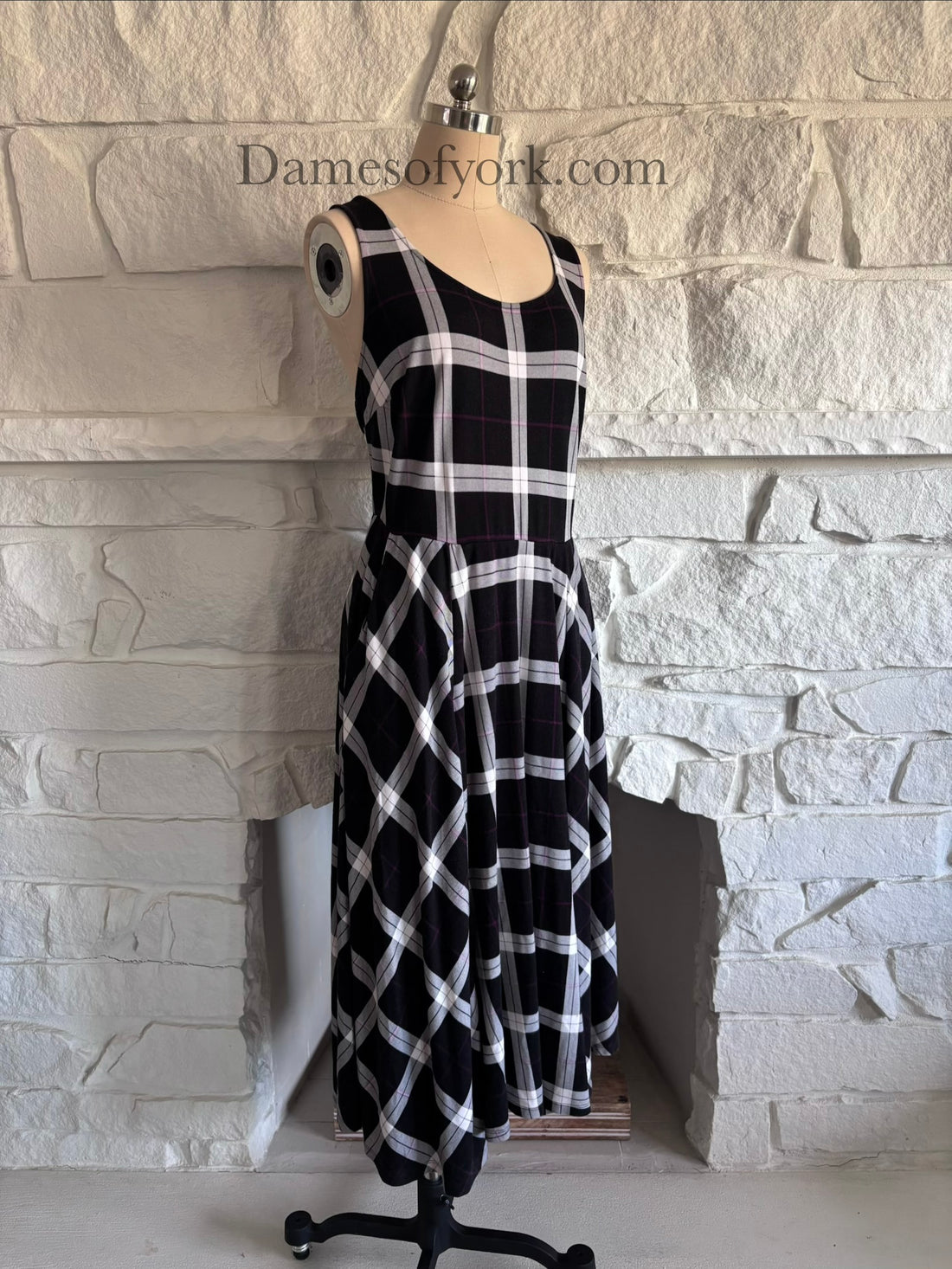Diagonal view of soft stretchy plaid dress on mannequin showing skater silhouette