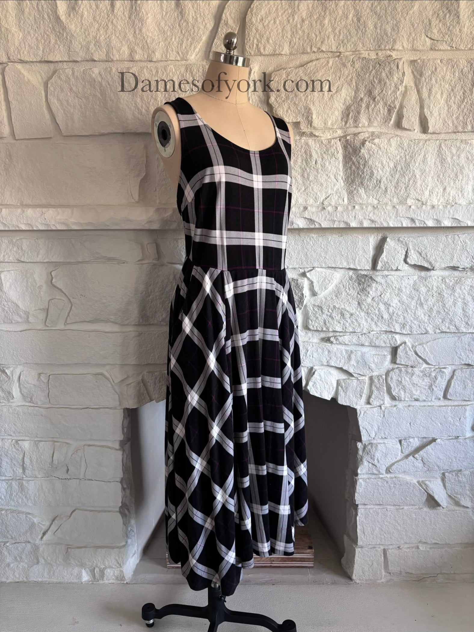 Diagonal view of soft stretchy plaid dress on mannequin showing skater silhouette