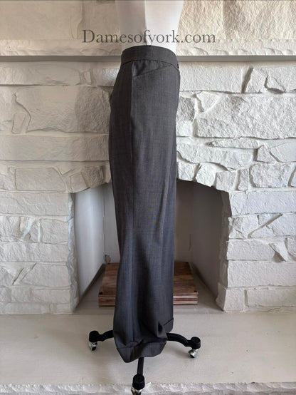 Side view of tailored grey trousers on mannequin with clean structured lines