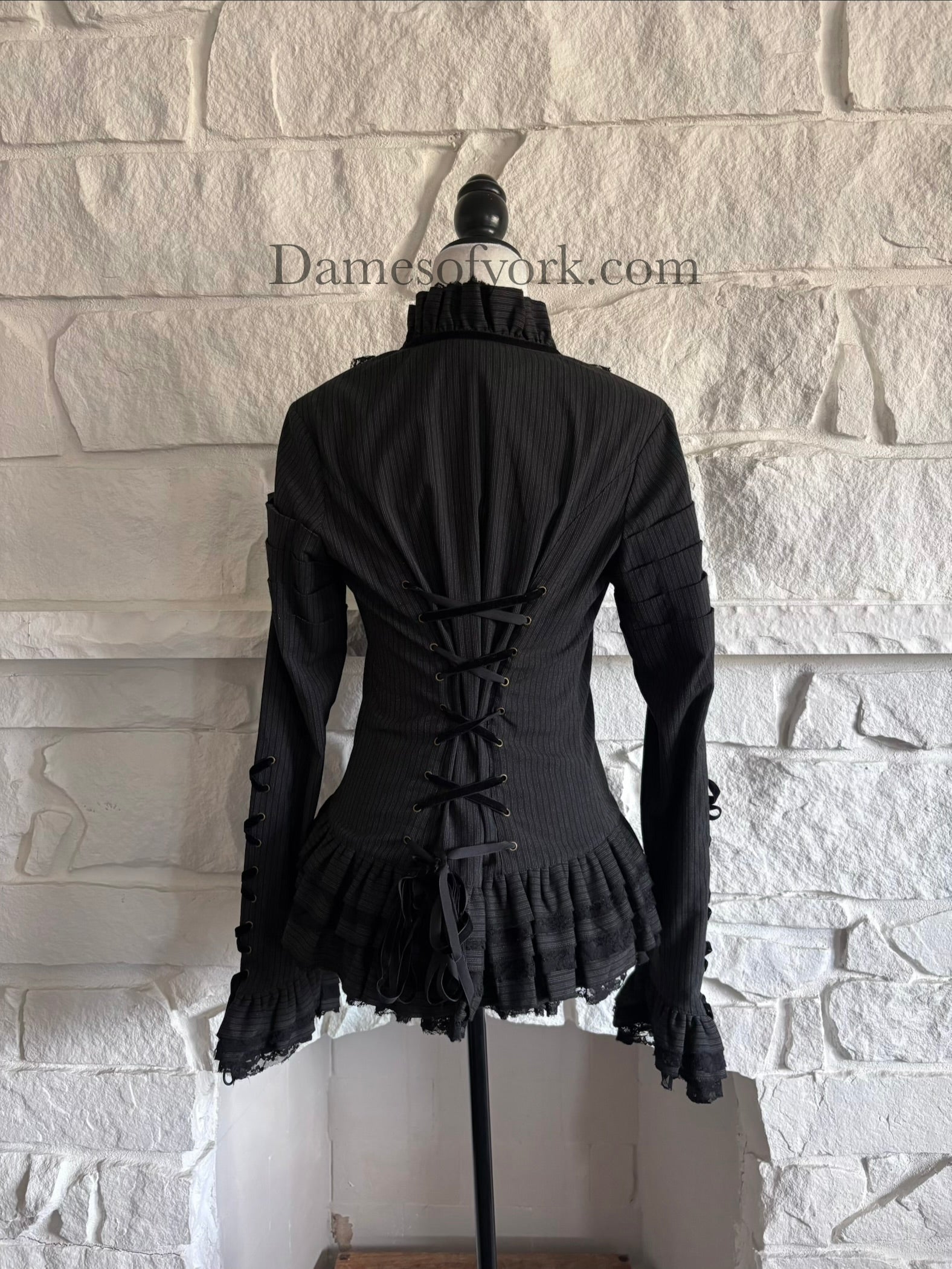 Back view of striped gothic jacket on mannequin with adjustable lace-up back