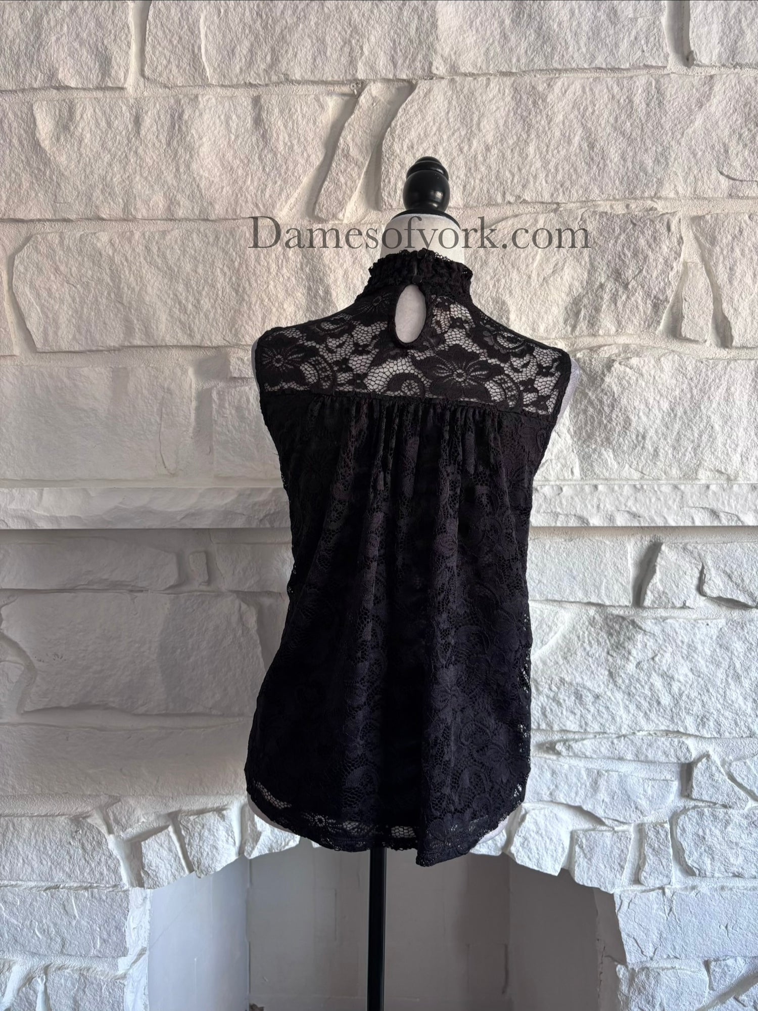 Back view of the Nocturne Lace Blouse showing the black lace overlay and elegant high-neck silhouette.