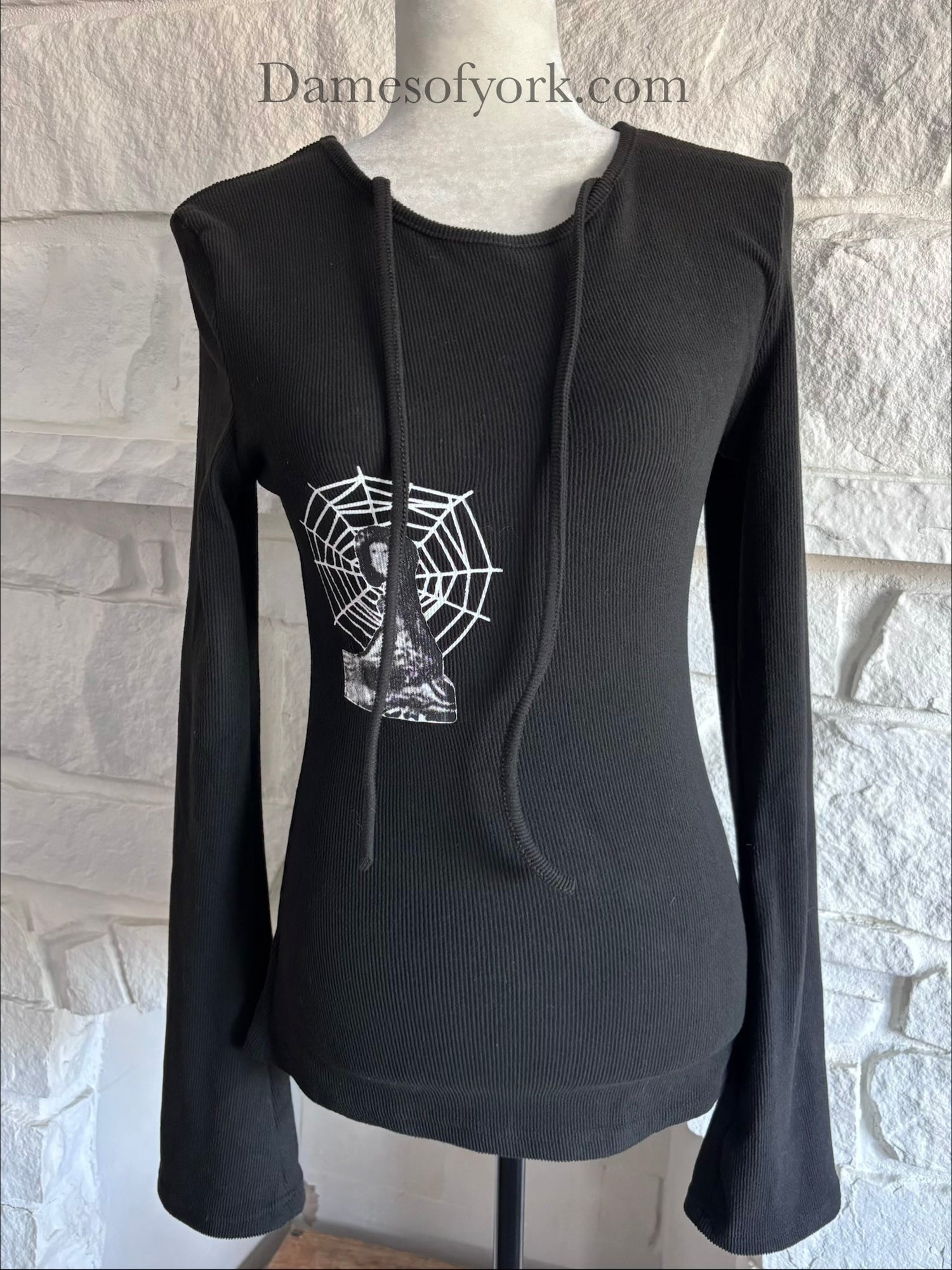 Close-up detail of the Webbed Phantom Sweatshirt featuring the spiderweb graphic with the mysterious abstract figure.