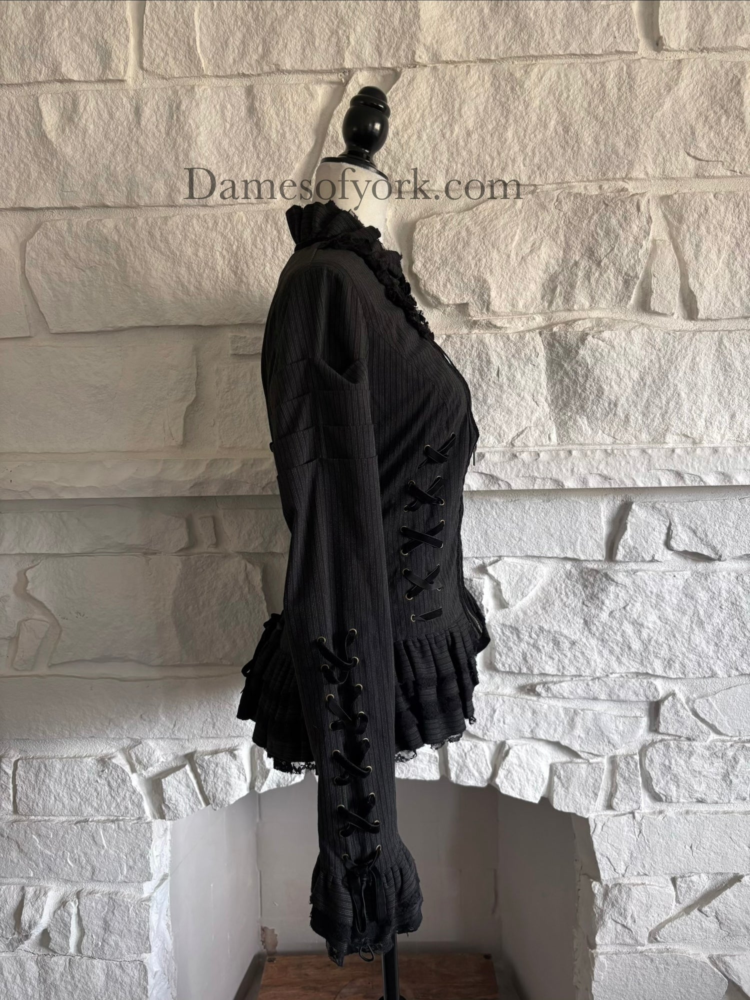 Side view of grey corporate goth jacket on mannequin with sleeve lacing and layered lace hem