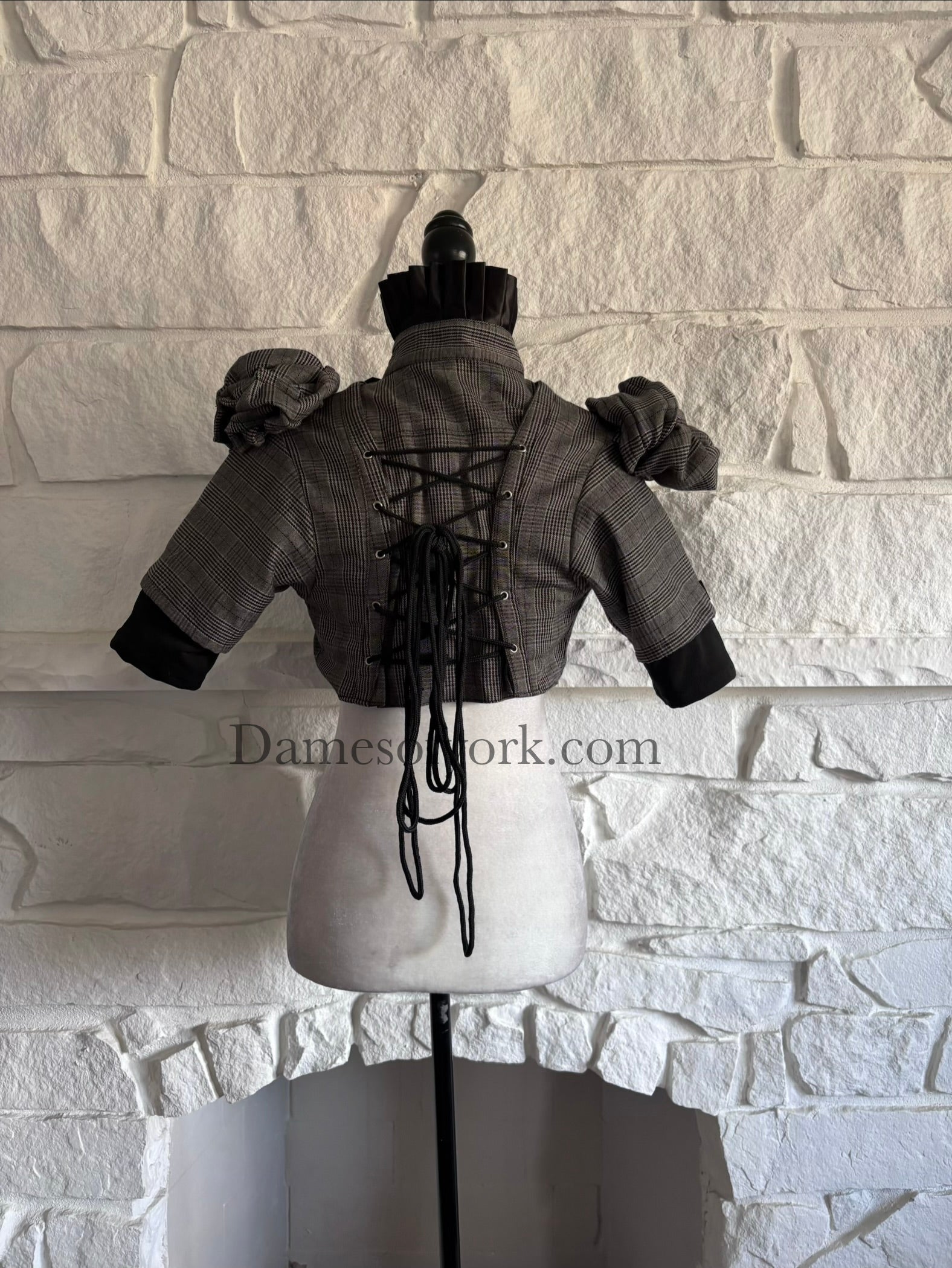 Back view of plaid gothic bolero on mannequin with adjustable black lace-up back