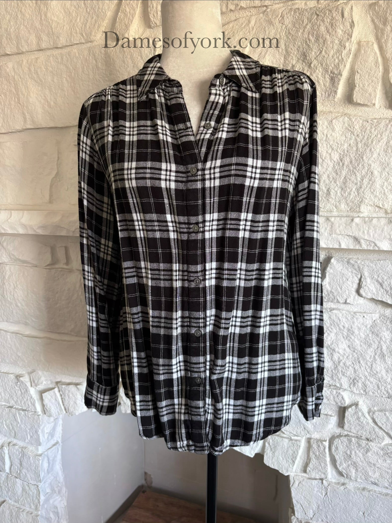 Close-up view of black and white plaid button-up shirt showing the plaid pattern in detail