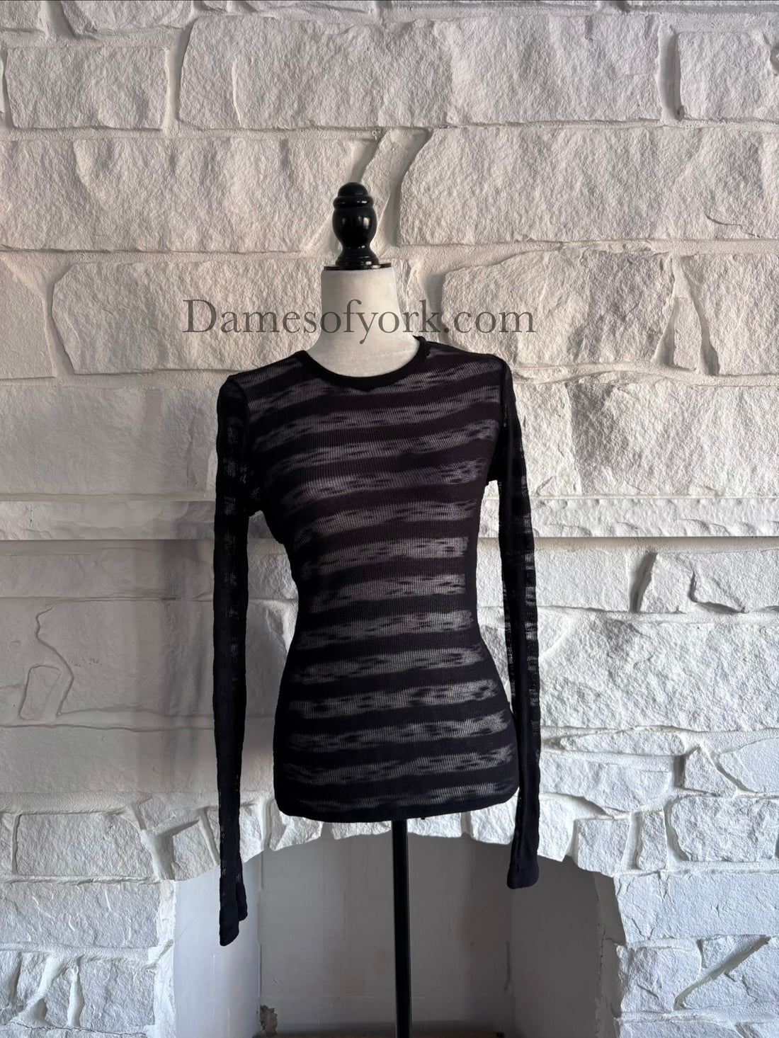 Front view of the Broken Hart Striation Shirt by Heavy Red, a black knit long sleeve top with alternating solid and sheer horizontal stripes.