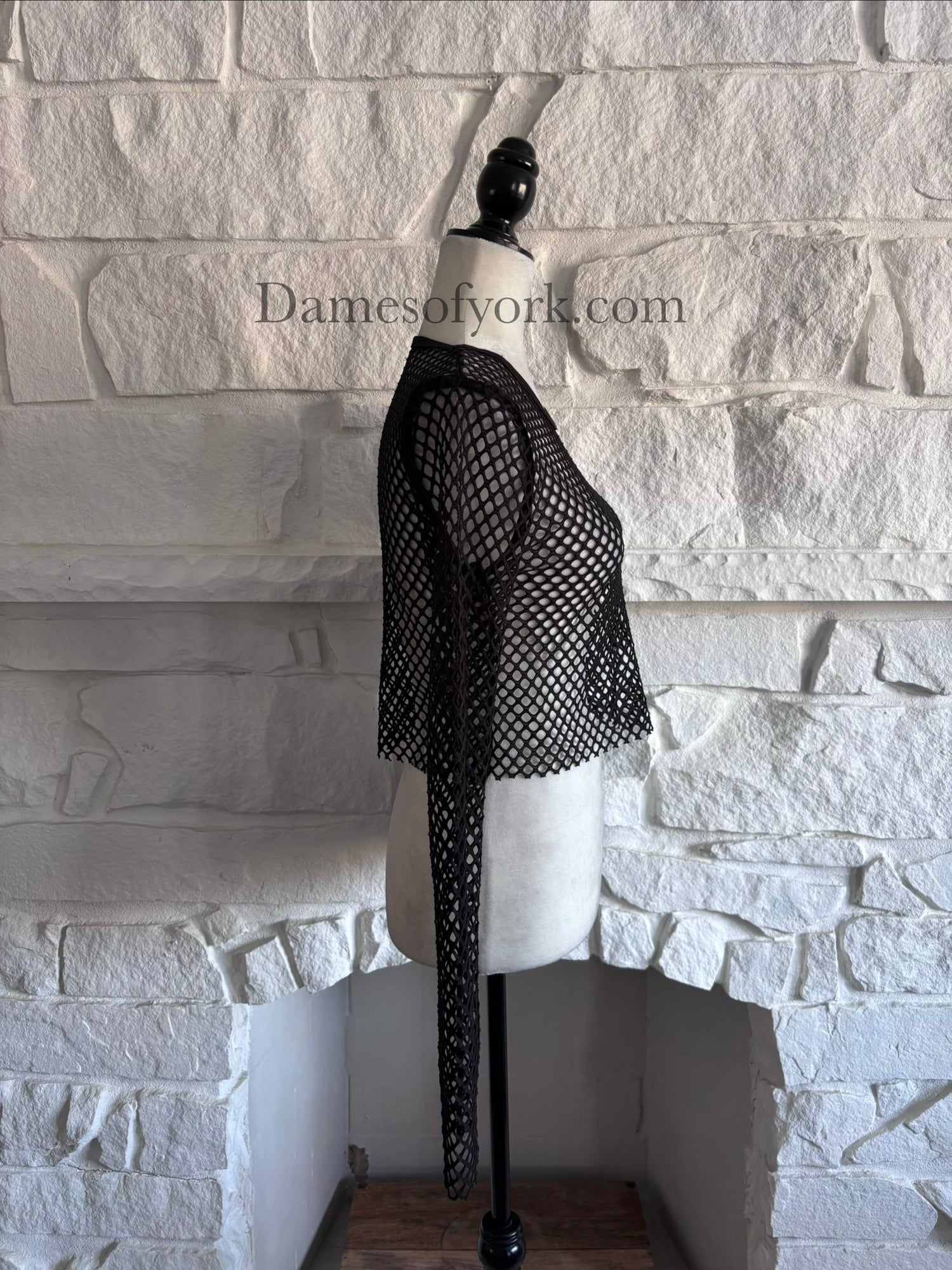 Side view of the Raw Edge Mesh Crop Top highlighting the fitted stretch mesh material and raw edge hem.