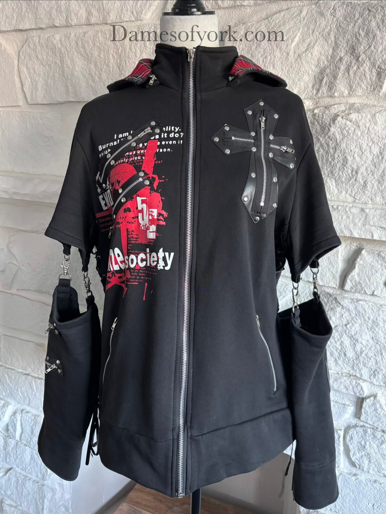 Close-up detail of the Stray Voltage Hoodie featuring the plaid cat ear hood and zipper hardware accents.