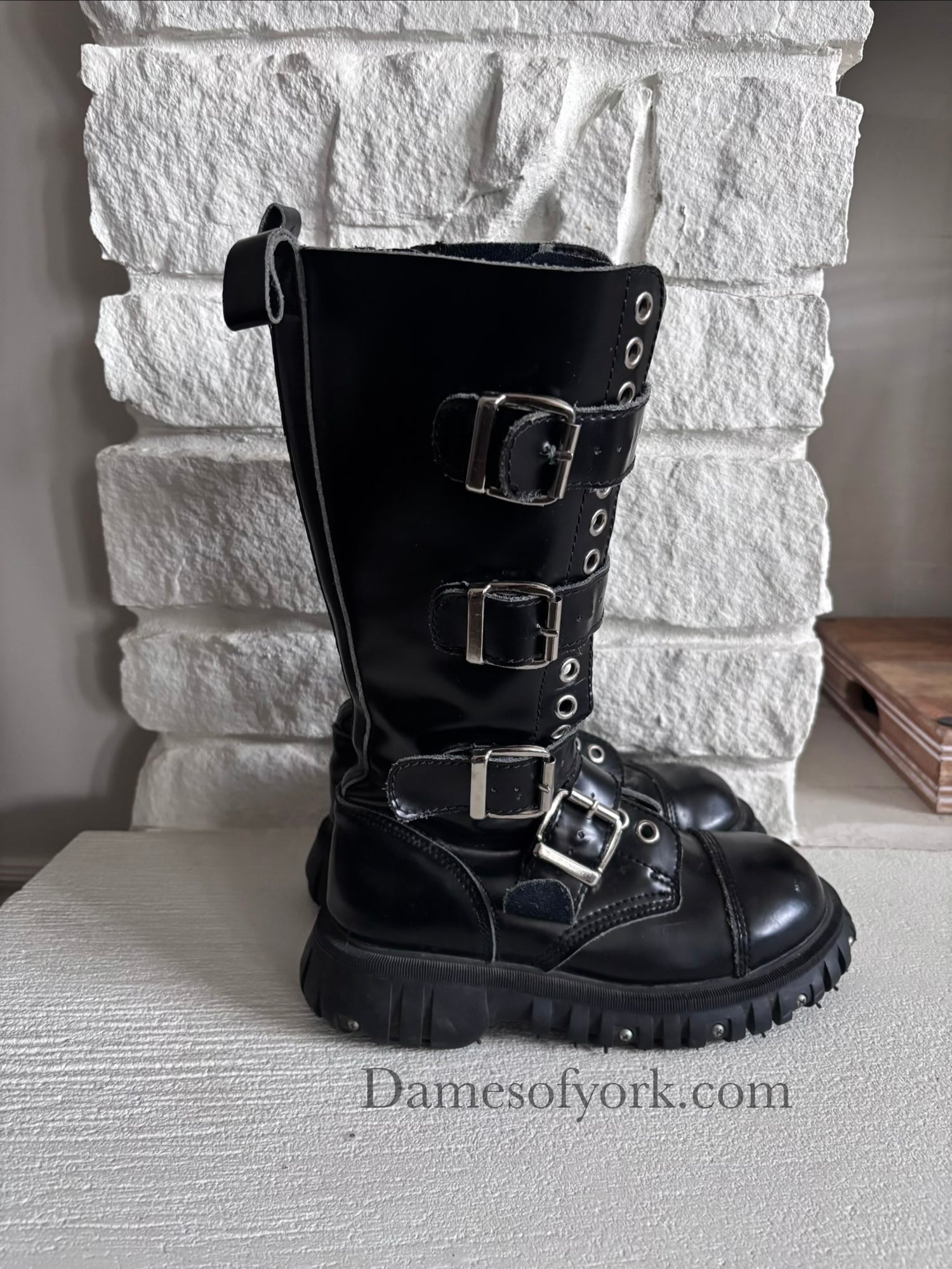 Right side view of the Rivet Command Boots highlighting the thick screw-detailed sole and mid-calf height.