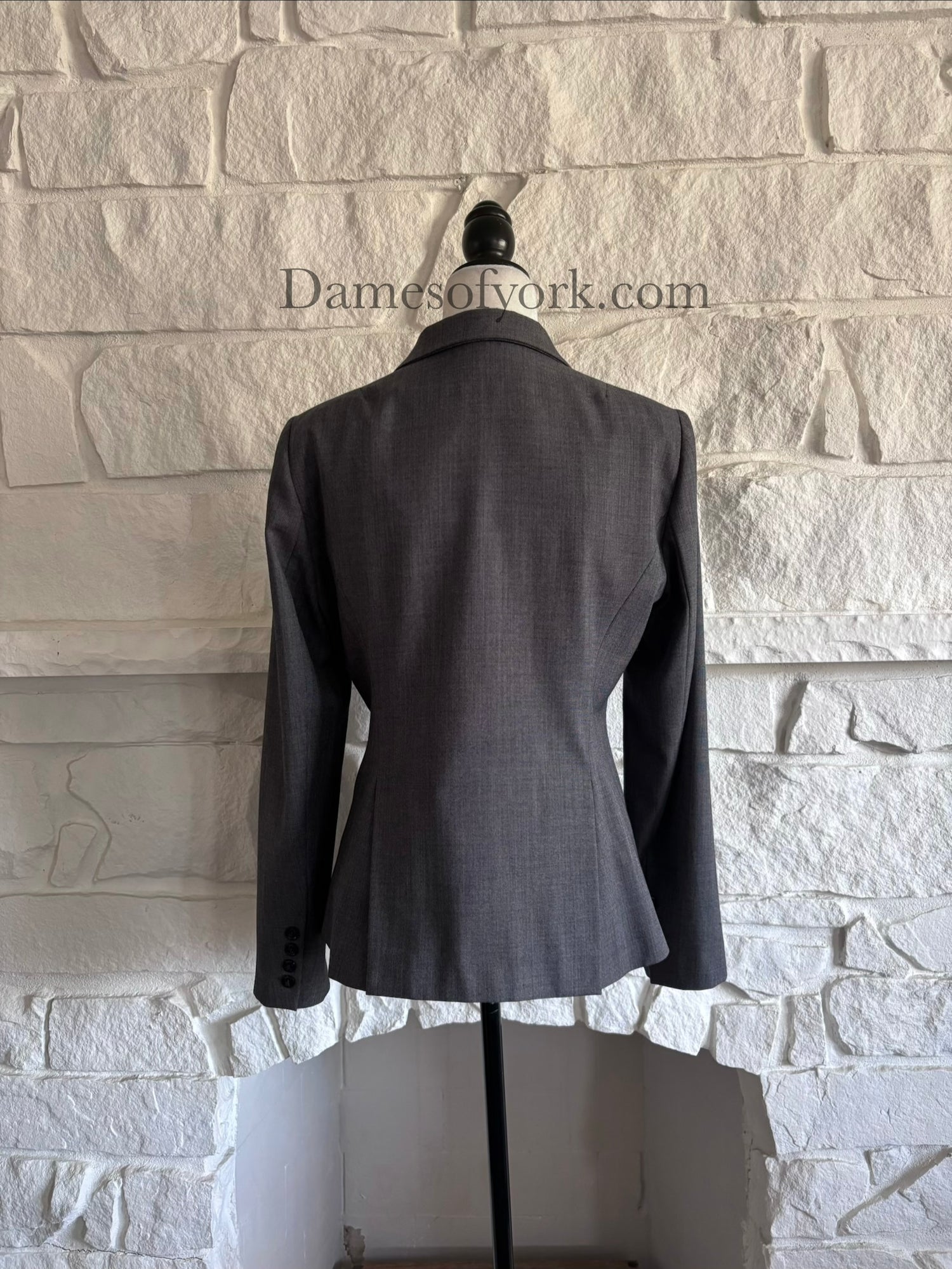 Back view of grey business style blazer on mannequin with tailored fit