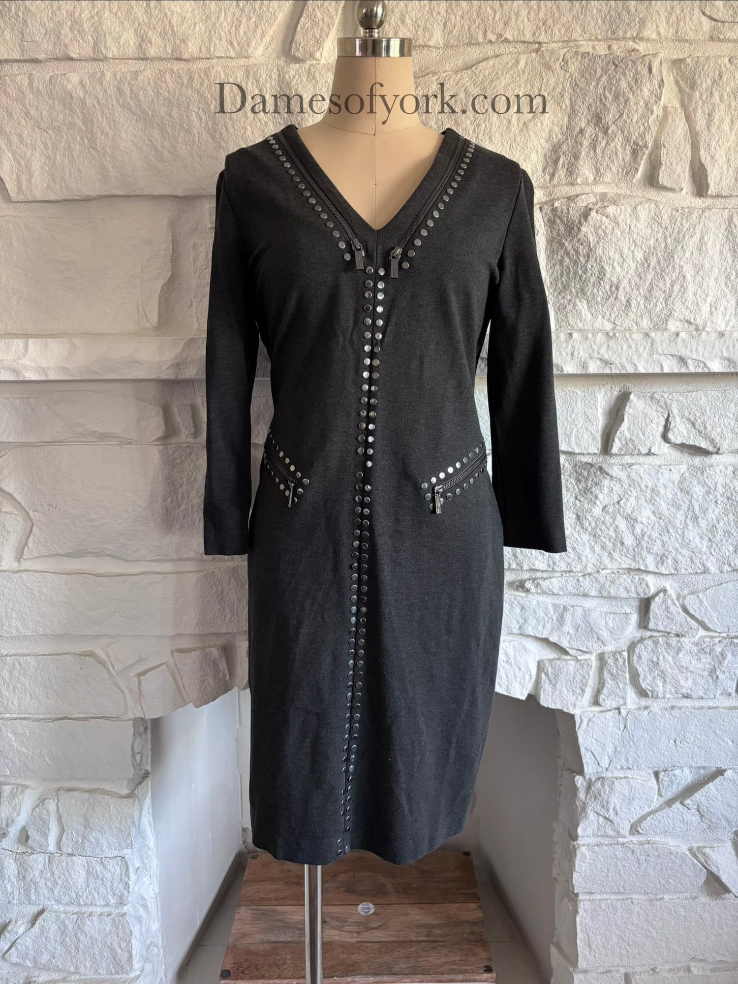 Front view of fitted grey corporate gothic dress on mannequin with silver studs and zipper details